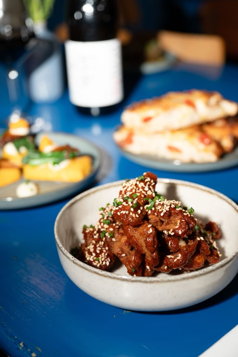 Crispy oyster mushrooms and small plates on a blue table