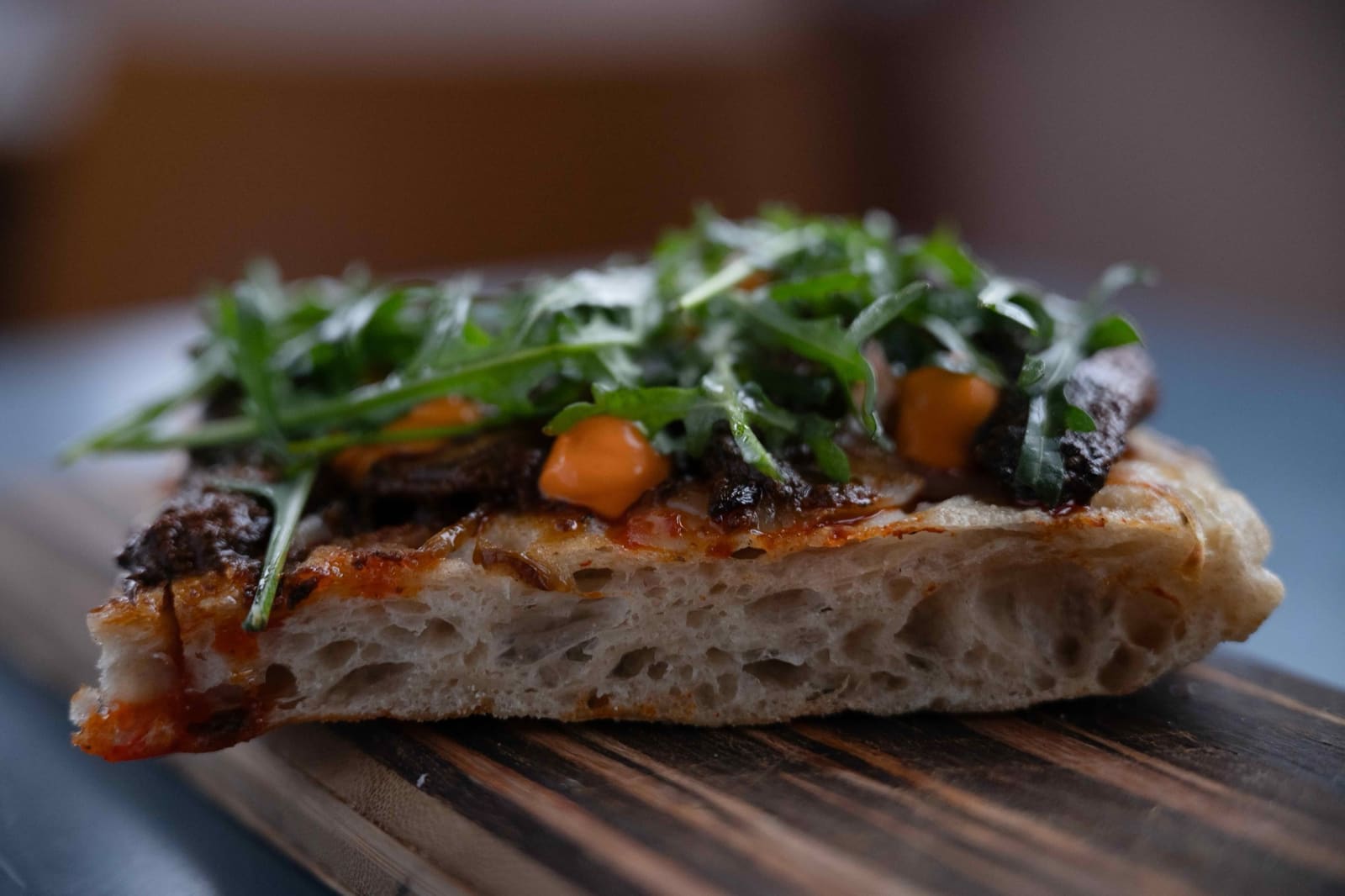 A slice of Roman pizza with smoked portobello and rocket
