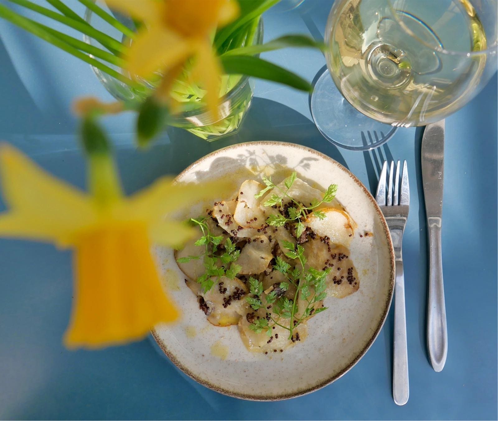 A plate and a glass of white wine
